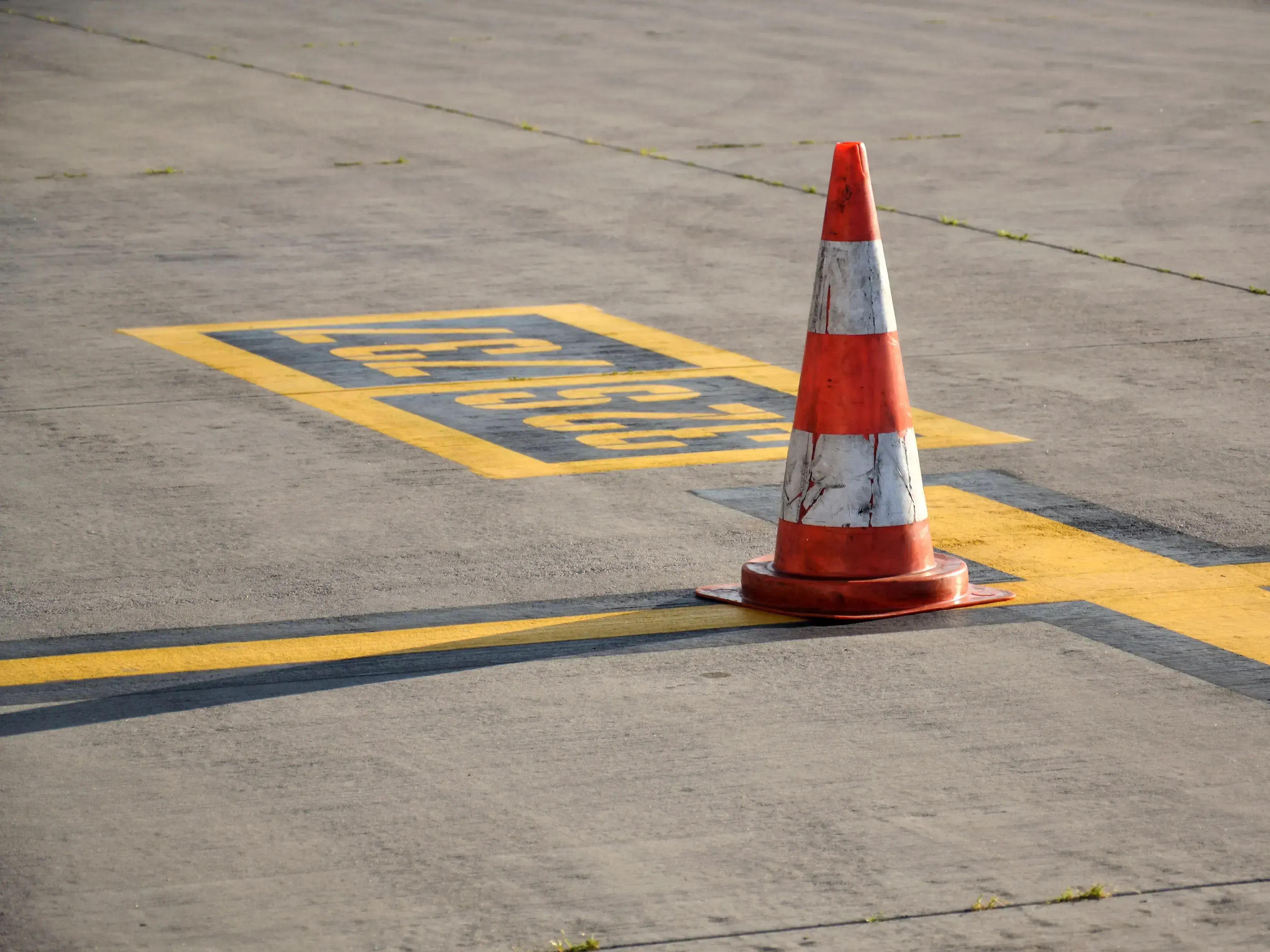 A traffic cone standing on a runway